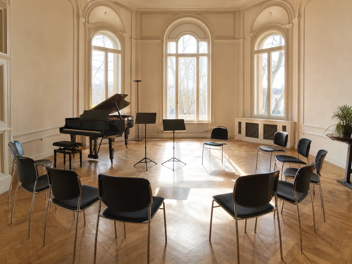 Unterrichtsraum einer Musikschule mit Flügel und Notenständern, Thema Lehrkräfte und Herrenberg-Urteil